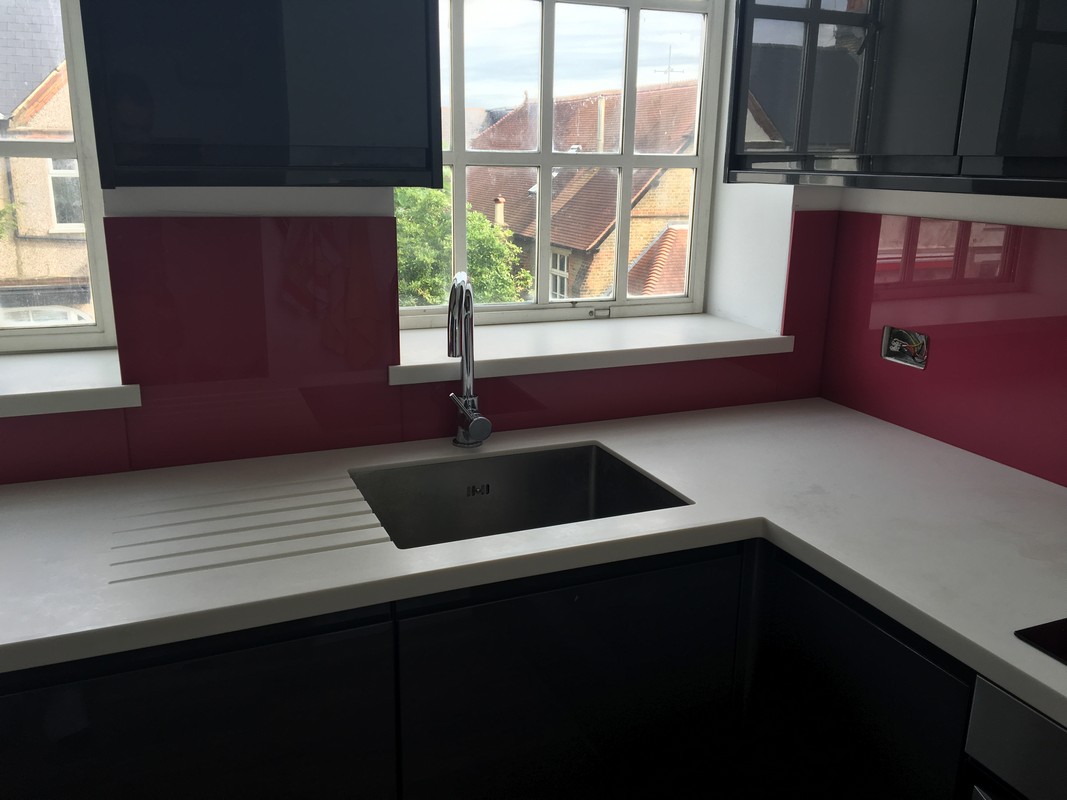 Deep plum coloured glass splashback in modern Battersea kitchen